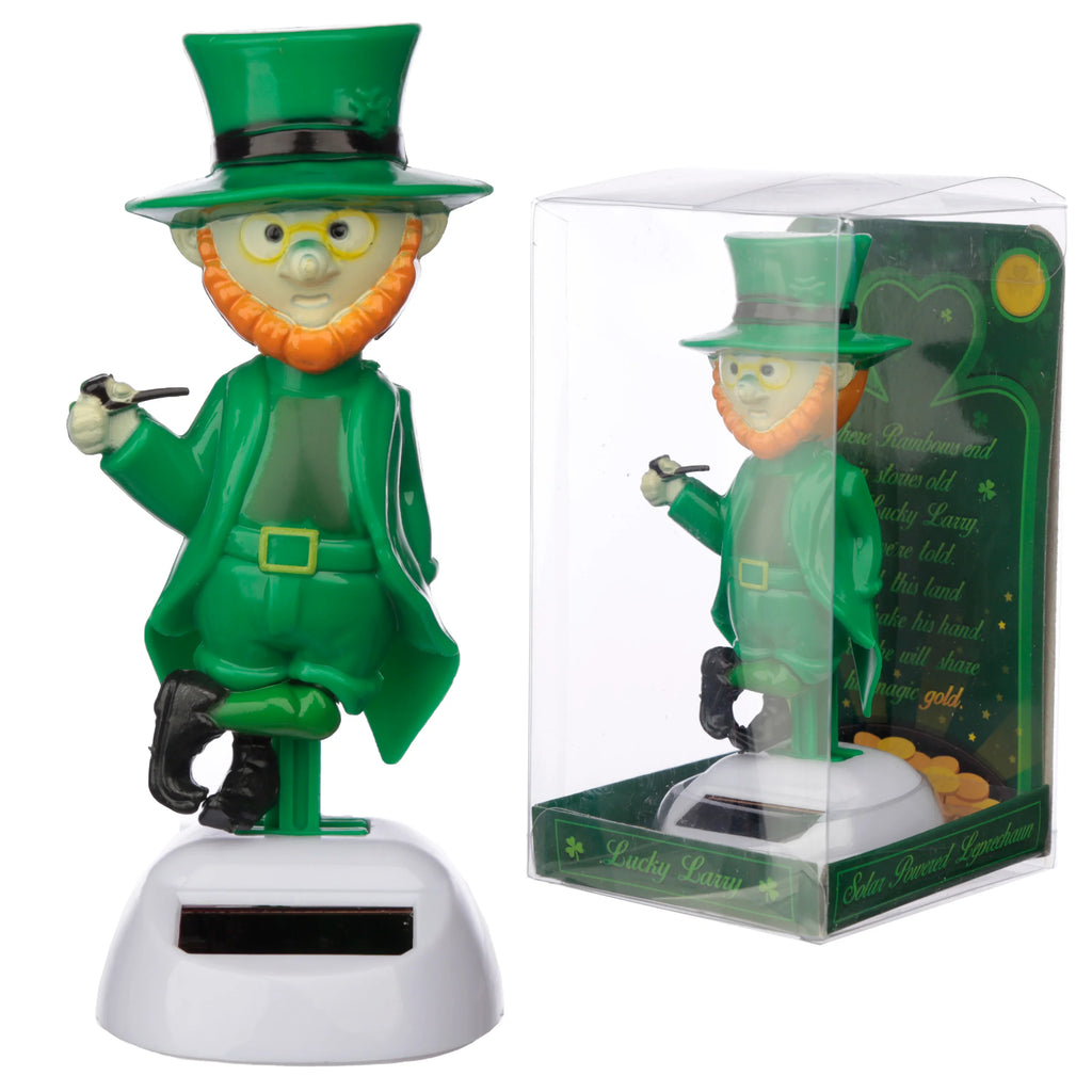Front view of a green Leprechaun Solar Pal figure with an orange beard, top hat, and pipe, standing on a white solar-powered base. It is shown next to its clear plastic retail packaging with green backing.