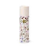 Front view of a cylindrical Nectar Meadows Solid Perfumed Stick Balm, a lip balm featuring a white background with a detailed floral and botanical pattern and a striped cap.