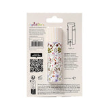 Back view of a white solid perfumed stick balm tube with a vibrant purple, green, and red floral pattern, displayed in white retail packaging.