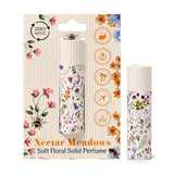 Front view of two Nectar Meadows solid perfumed stick balms on a white background. One balm is presented in its retail packaging, featuring colorful floral and bee illustrations, along with icons indicating zero waste, cruelty-free, vegan, palm oil-free, travel-friendly, and plastic-free attributes. The second matching balm stands upright beside the package, adorned with similar vibrant floral patterns.
