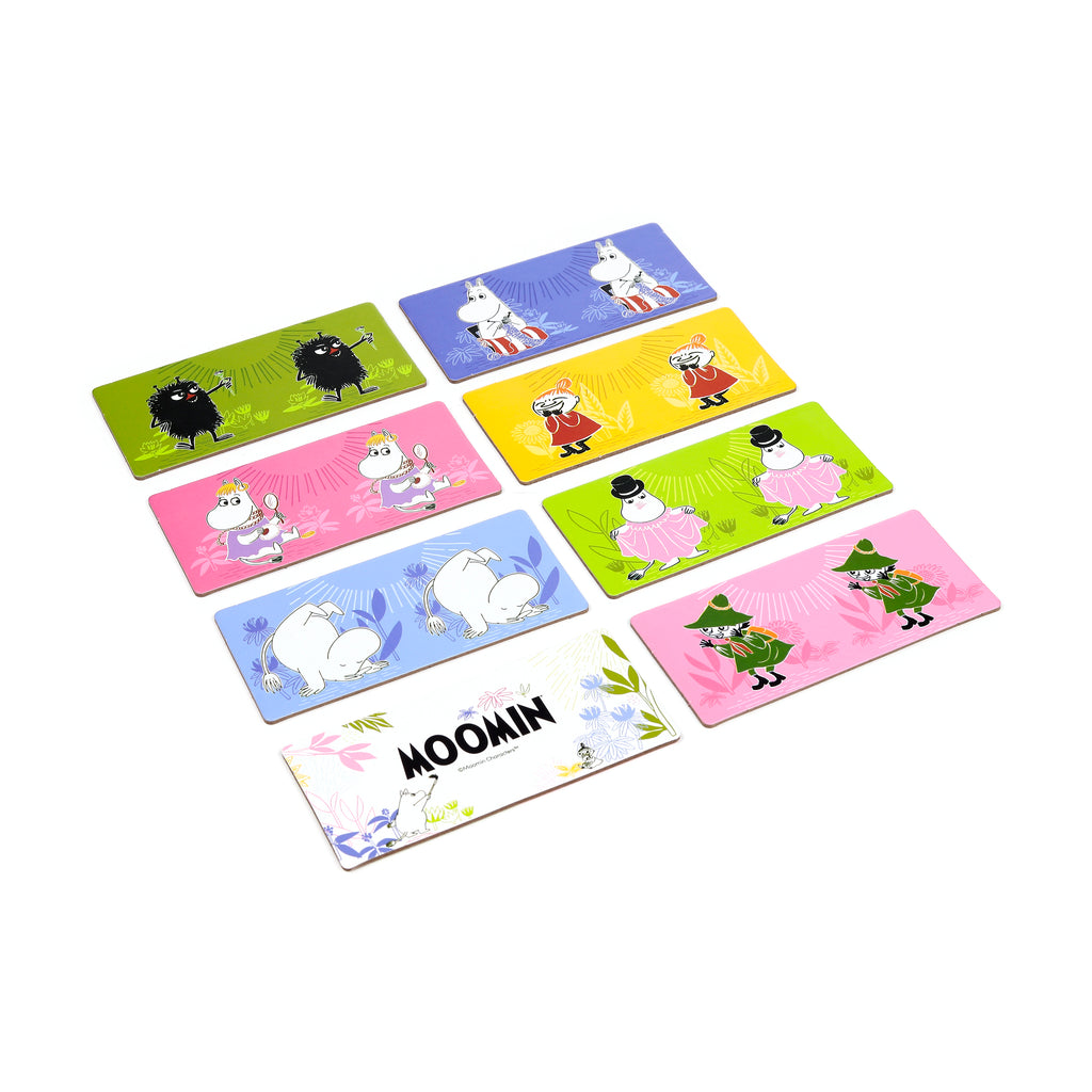 Angled overhead view of a Moomin kids' picture dominoes set, with colourful tiles featuring various Moomin characters and a Moomin logo tile, spread out on a white background.