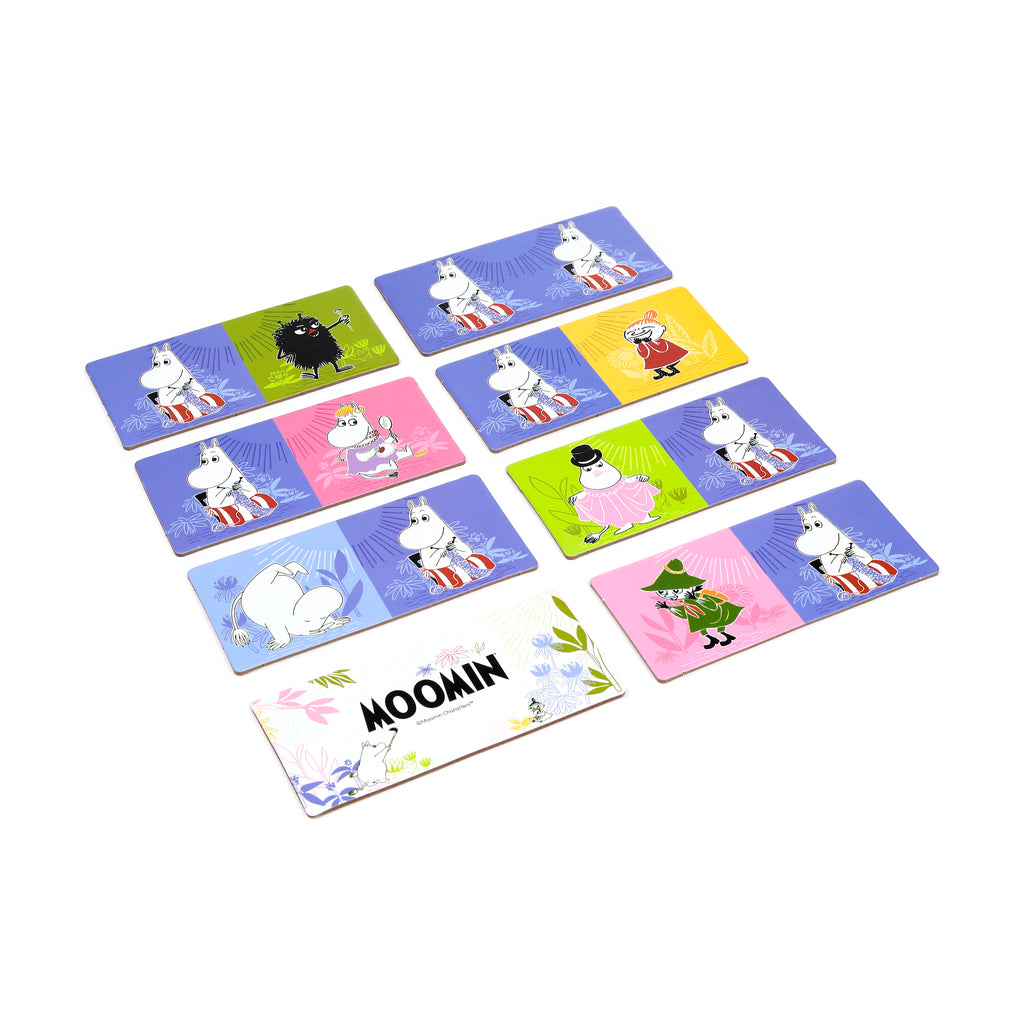 Angled view from above of a Moomin kids picture dominoes set, showing multiple rectangular tiles with colourful backgrounds and illustrations of Moomin characters, including one tile displaying the 'MOOMIN' logo.