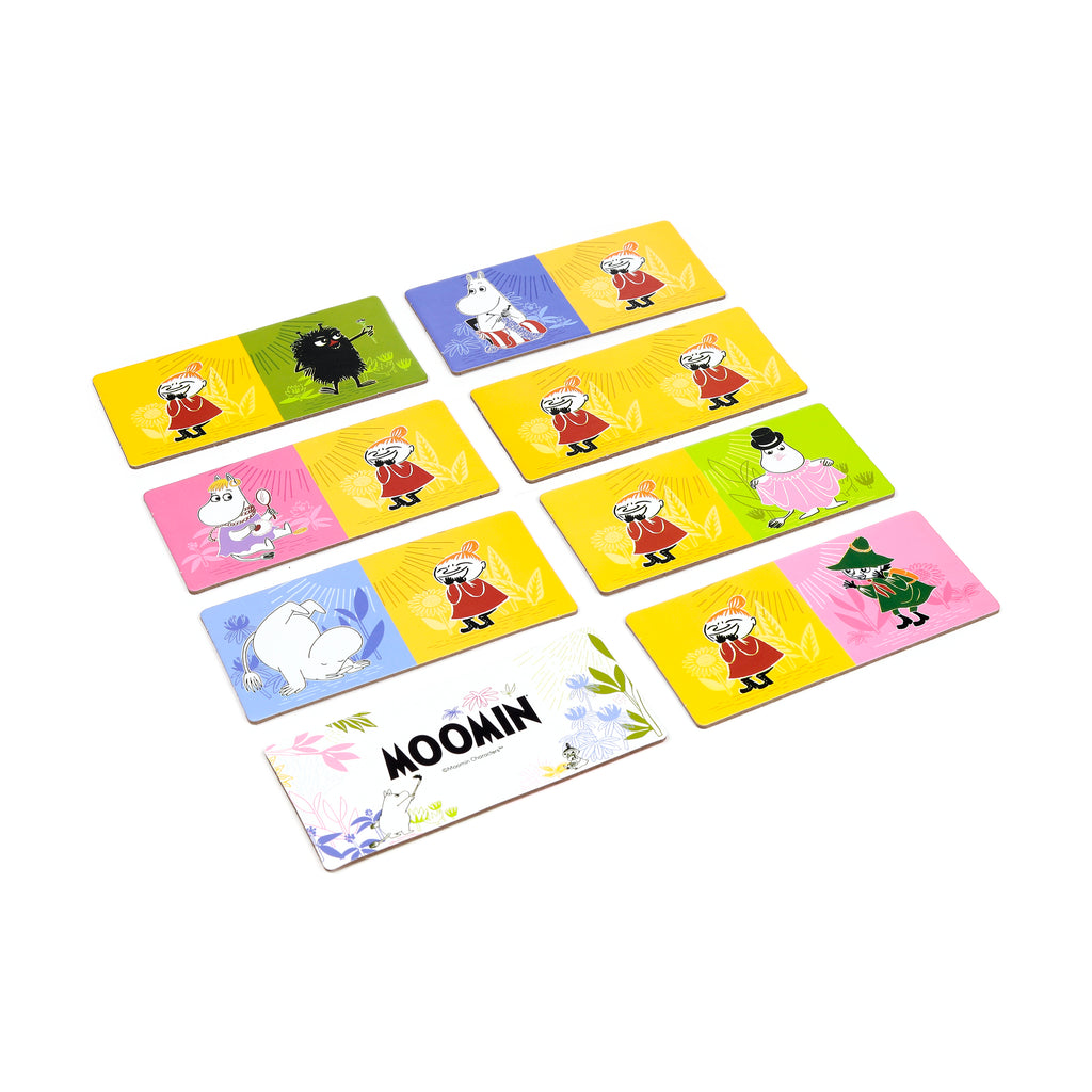 Moomin Kids Dominoes Set, angled view showing multiple picture tiles with Little My, Moomintroll, and other characters on various colourful backgrounds, including yellow, green, pink, and blue. One tile features the Moomin logo.