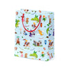 Front view of a large, light blue gift bag with red braided rope handles, featuring a colourful Knights and Dragons design including knights, dragons, a princess, a wizard, and a castle.