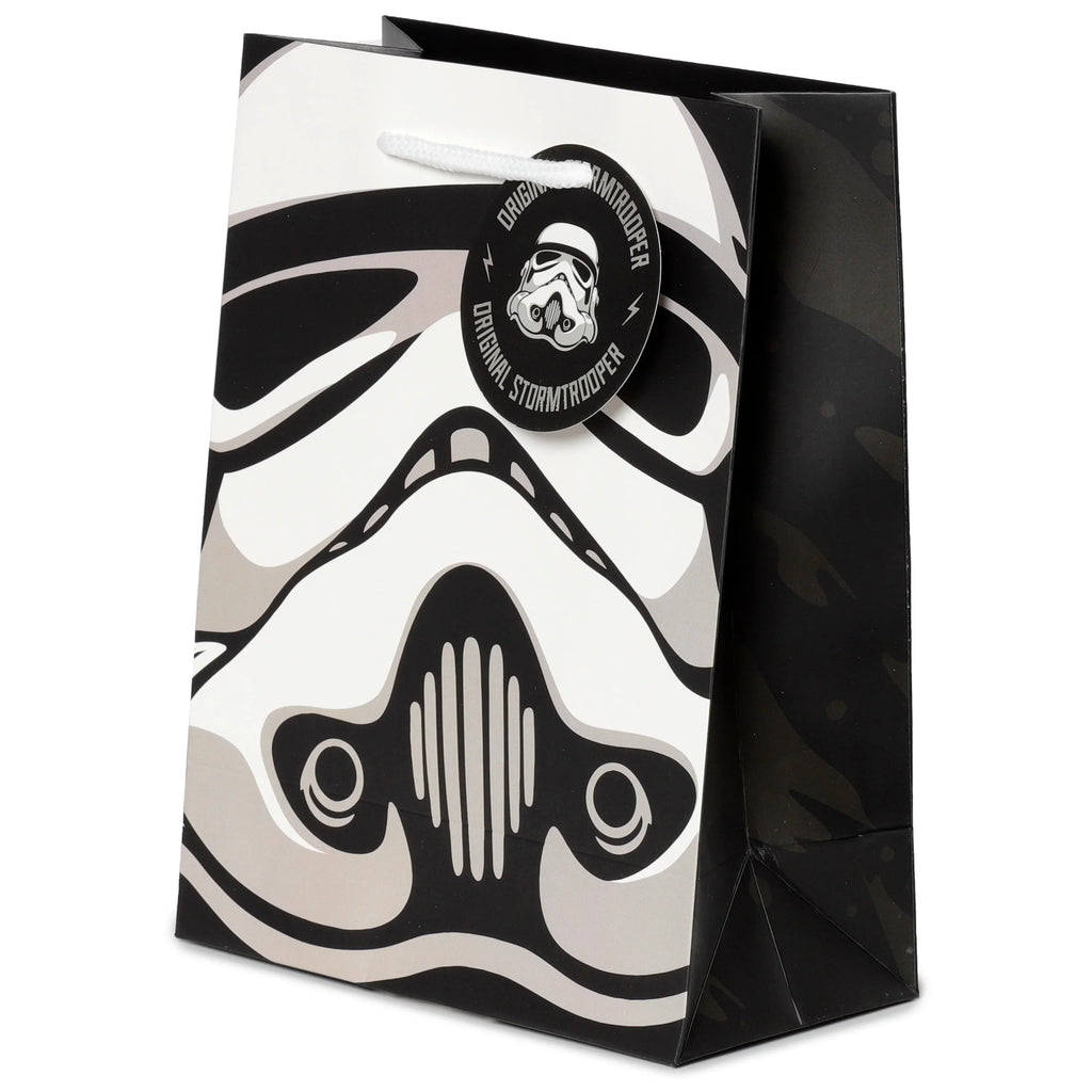 Medium gift bag, angled front view, featuring a black, white, and grey Stormtrooper helmet design, with white rope handles and a matching Stormtrooper tag.
