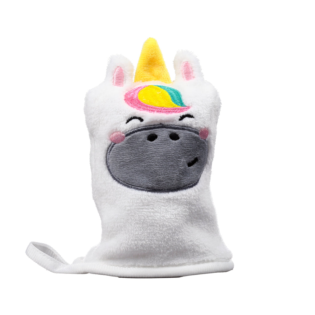 Front view of a white fluffy unicorn makeup remover glove, featuring a yellow horn, rainbow-coloured mane, and an embroidered grey face with pink cheeks and a happy expression. A white hanging loop is visible.