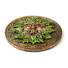Angled view of a round Greenman ashcatcher incense burner featuring a bronze face with green leaves and turquoise Celtic knotwork.