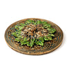 Round Greenman ashcatcher incense burner with bronze Celtic knot design and green leafy face, shown from an angled top view.