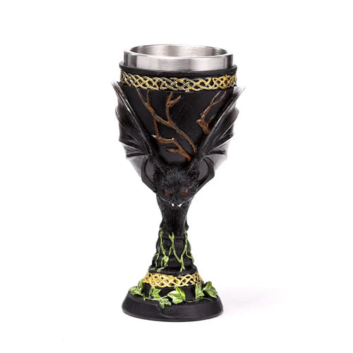Front view of a decorative black bat goblet, featuring a prominent bat figure, golden Celtic knot bands, and green ivy details.