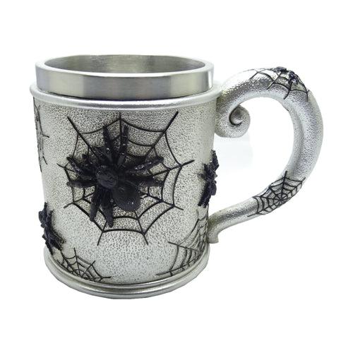 Silver decorative tankard depicting a large black spider on a web, with smaller spiders and webs wrapping around its textured body and handle.