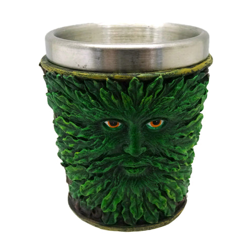 Front view of a decorative shot glass, featuring a green Treeman face with intricate foliage and orange eyes, finished with a metallic silver-coloured rim.