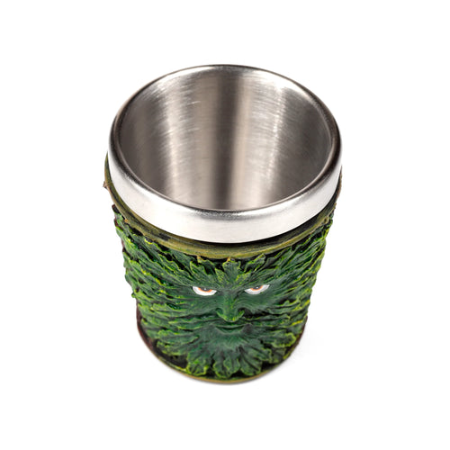 Elevated view of a decorative Treeman shot glass with a detailed green leaf-covered face and brown eyes, featuring a silver-coloured inner cup.