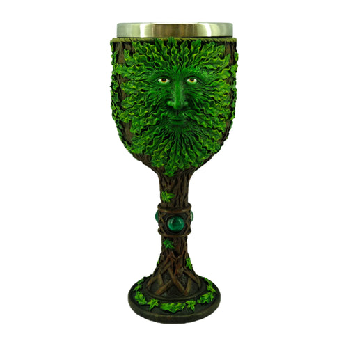 Front view of a decorative Treeman goblet, featuring a green leaf face with orange eyes, a tree branch stem with green gems, and a metallic inner lining.