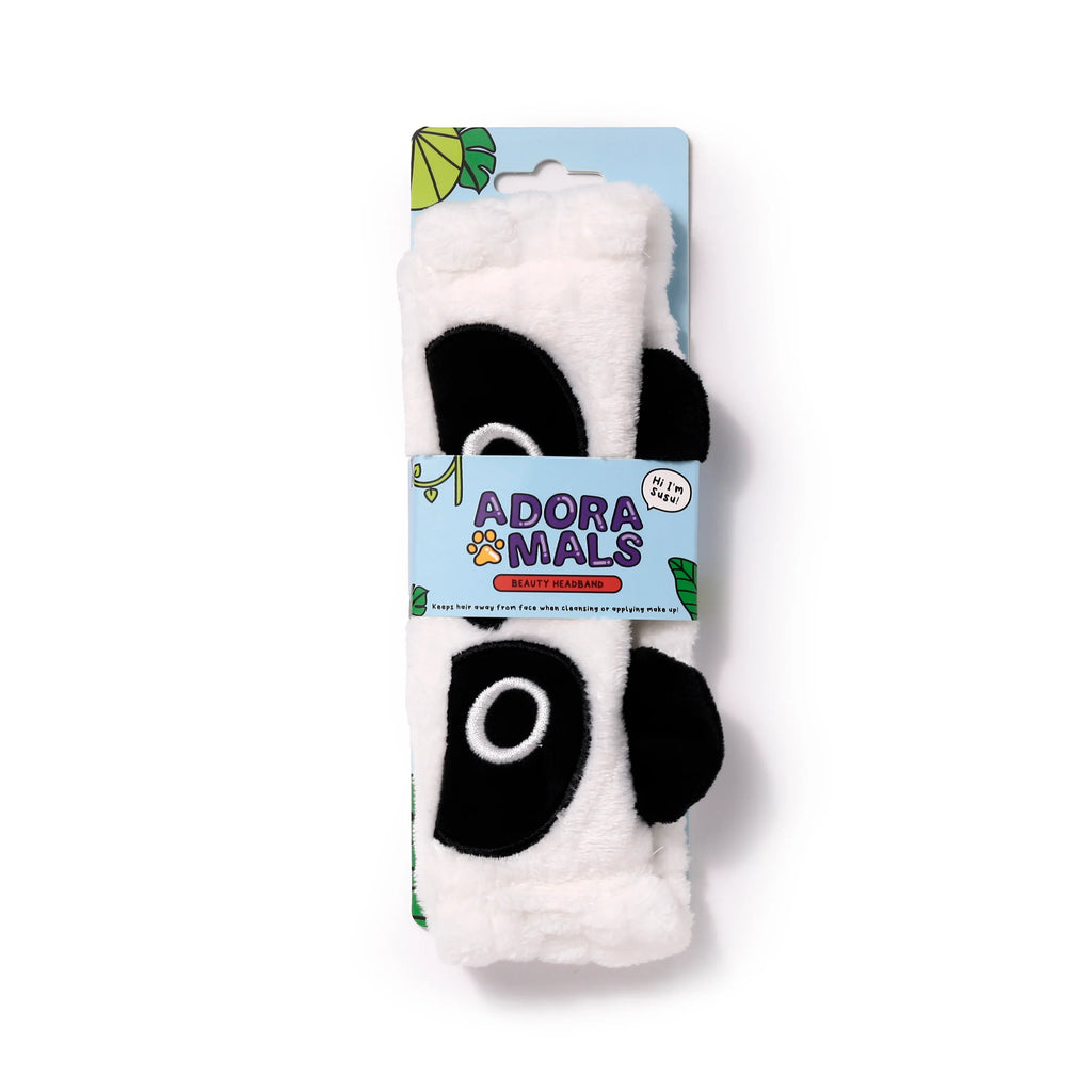 Front view of an Adoramals Susu the Panda plush headband, white and black with prominent black eye patches and ear details, presented on a light blue retail card with green leaf graphics.