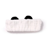 Front view of a white plush headband with black panda ears.