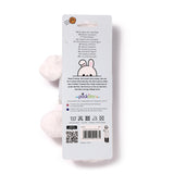 Back view of a white plush rabbit headband on its retail packaging.