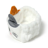 Front-angled view of a white plush cat headband with grey and orange ears, embroidered whiskers, and pink cheek details on a white background.
