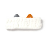 Front view of a white plush headband with grey and orange cat ears.