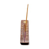 Angled top view of a sheesham wood ashcatcher incense stick burner, featuring a brass-coloured pentagram and stars inlay. A beige incense stick with a purple tip is inserted.