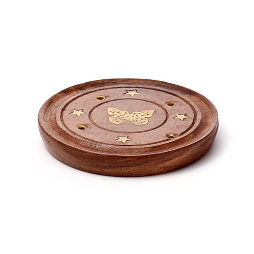 Angled view of a round Sheesham wood incense holder and ashcatcher, featuring a golden-coloured metallic butterfly inlay, star detailing, and multiple holes for incense sticks and cones.