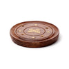 Angled view of a dark brown round Sheesham wood incense holder, featuring a gold butterfly inlay surrounded by gold stars and small holes for incense sticks.