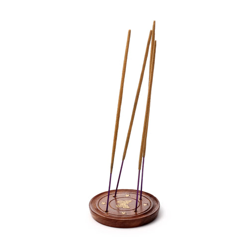 Angled view of a round, dark Sheesham wood incense ashcatcher, featuring a central golden butterfly inlay and smaller star inlays. Several incense sticks with purple tips are held upright in the base.