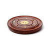 Angled view of a round dark brown sheesham wood incense holder, featuring a brass Yin Yang inlay, star embellishments, and openings for sticks and cones.