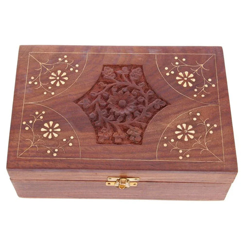 Angled view of a decorative Sheesham wood trinket box, showcasing its rich brown colour and ornate lid with a carved central floral design and lighter inlaid floral patterns, plus a brass-coloured clasp on the front.