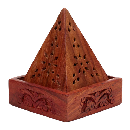 Angled view of a reddish-brown Sheesham wood pyramid incense holder box, showing intricate perforated floral fretwork on its pyramid top and carved decorative patterns on its base.
