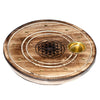 Angled top-down view of a round mango wood incense holder and ashcatcher, featuring a central etched Flower of Life design, concentric grooves, small brass-coloured holes for incense sticks, and an integrated brass-coloured cup for cones.