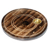 Angled overhead view of a round dark brown mango wood incense holder, featuring a black Hamsa symbol, concentric carved rings, brass-coloured holes for incense sticks, and a brass-coloured cone burner cup.