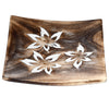 Angled view of a square mango wood incense ashcatcher, featuring three white carved floral patterns with golden stick holders.