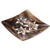 Angled view of a square dark mango wood ashcatcher incense stick burner, featuring three white carved floral patterns, each with a central stick hole.