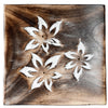 Top-down view of a dark brown mango wood square incense holder and ashcatcher, featuring three white carved floral designs with brass eyelets for incense sticks.