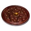 Angled view of a round sheesham wood incense holder and ashcatcher, featuring a carved star pattern with golden inserts for incense sticks and a central golden cup for cones.