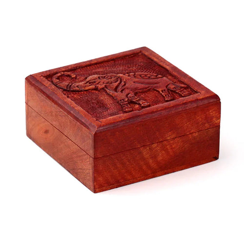 Reddish-brown mango wood trinket box with a carved elephant design on the lid, presented from an elevated angled view.