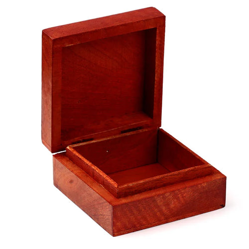 Angled view of an open reddish-brown wooden trinket box, revealing its empty interior.