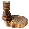 Angled view of a mango wood backflow incense burner, showing a dark brown turned wood holder with a brass-coloured cone insert and a lighter wood base with intricate swirling carvings.