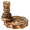 Angled view of a dark brown mango wood incense burner, featuring a tall, turned pillar with a golden cup and a separate wavy-edged base with a deeply carved Om symbol.
