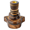 Angled view of a dark, carved mango wood backflow incense burner, featuring a Hamsa hand-shaped base with intricate details and a gold-coloured insert at the top.
