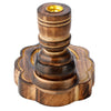 Angled view of a dark brown carved mango wood backflow incense burner, featuring an Om symbol on its scalloped base, a grooved central pillar, and a gold-coloured metal cup.