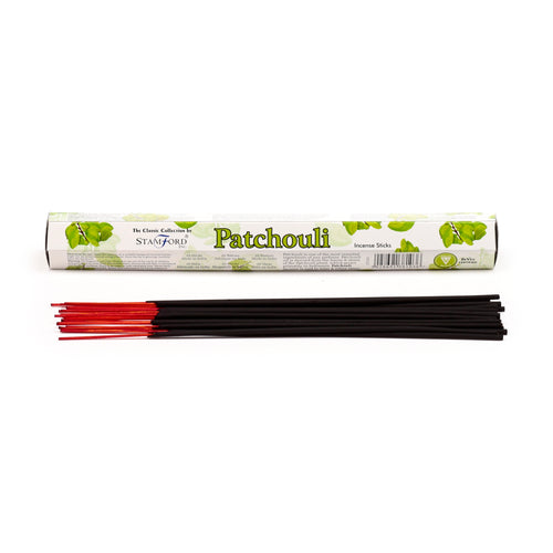 Front view of a white and green box of Patchouli incense sticks, with a bundle of dark incense sticks featuring red tips laid out in front.