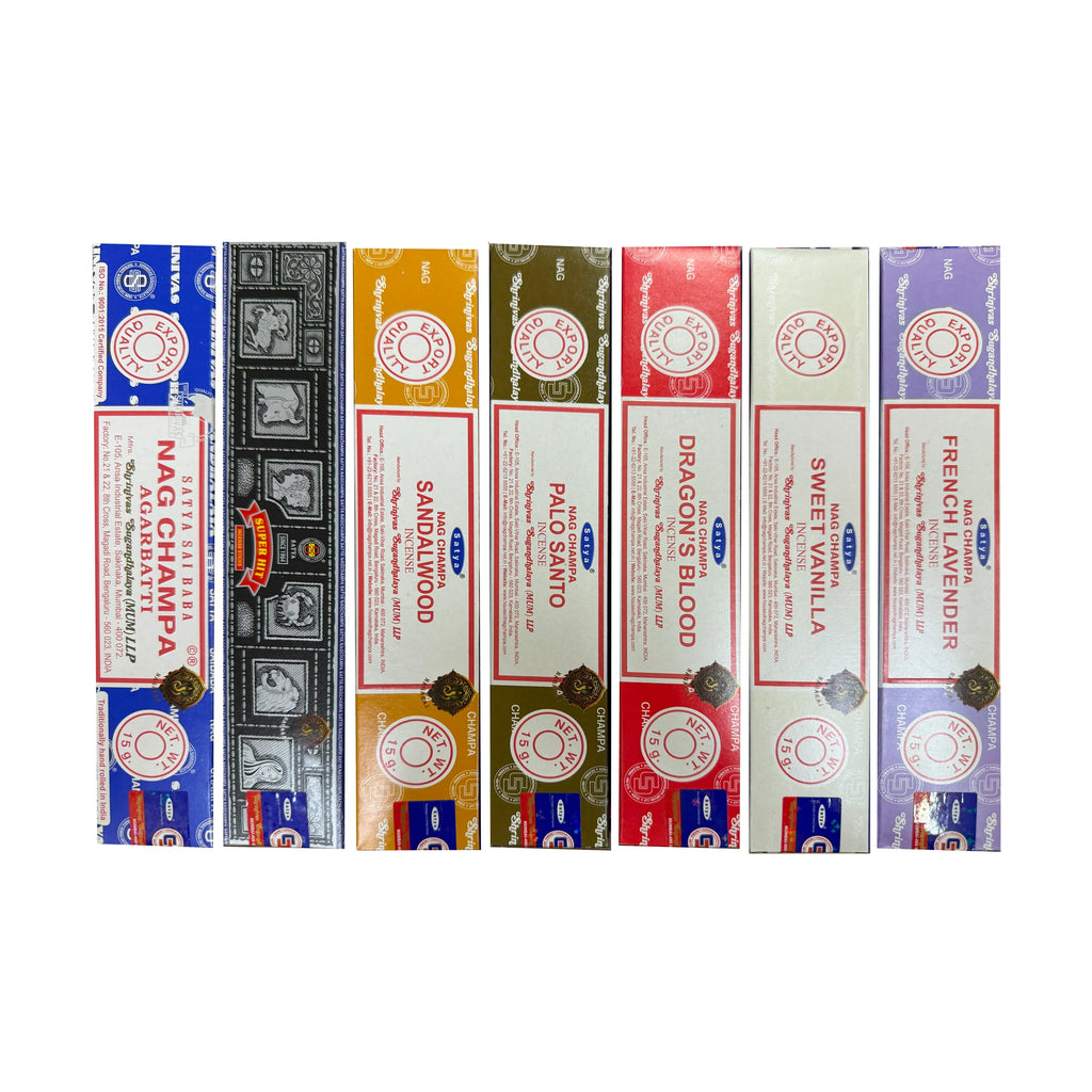 Front view of seven colourful boxes of Satya mixed incense sticks, displaying scents including French Lavender, Sweet Vanilla, Dragon's Blood, Palo Santo, Sandalwood, Super Hit, and Nag Champa Agarbatta, each box weighing 15g.