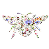 Top view of a bee-shaped wooden jigsaw puzzle, depicting a colourful illustration of flowers and bees.