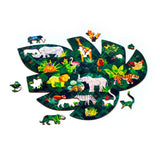 Angled view of a partially assembled wooden Animal Kingdom jigsaw puzzle, forming a large green leaf shape with colourful animal-shaped pieces and jungle patterns.