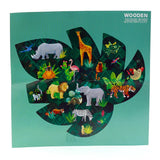 Front view of a wooden jigsaw puzzle, depicting a colourful 'Animal Kingdom' scene. The design features various wild animals including a giraffe, elephant, lion, tiger, rhinoceros, and flamingo, set within a dark green, leaf-shaped jungle motif. The words 'WOODEN JIGSAW' are visible at the top right.