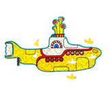 Assembled wooden jigsaw puzzle of a yellow submarine, shown in side profile. The colourful design includes red and white details, a propeller, periscopes, and characters in portholes, with smaller yellow submarine pieces scattered around.