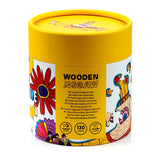 Angled view of a cylindrical 130pc wooden jigsaw puzzle container. The yellow and white packaging features colourful Beatles Yellow Submarine artwork, with 'WOODEN JIGSAW' text visible.