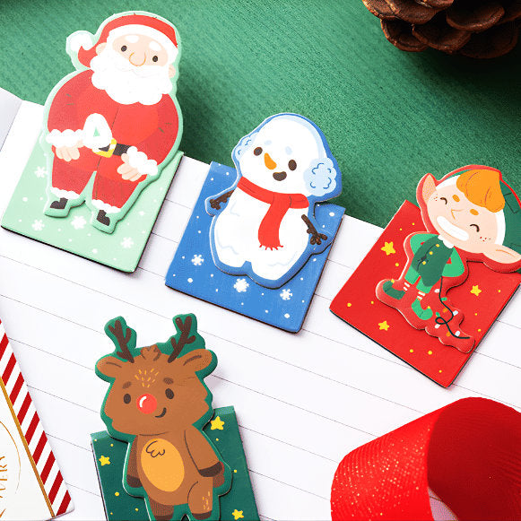 Christmas-themed stationery set with Santa Claus, snowman, and reindeer on a green background.