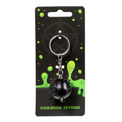 Front view of a novelty cauldron keyring, featuring a black cauldron charm and silver-coloured metal ring, presented on black retail packaging with bright green slime detailing, against a white background.